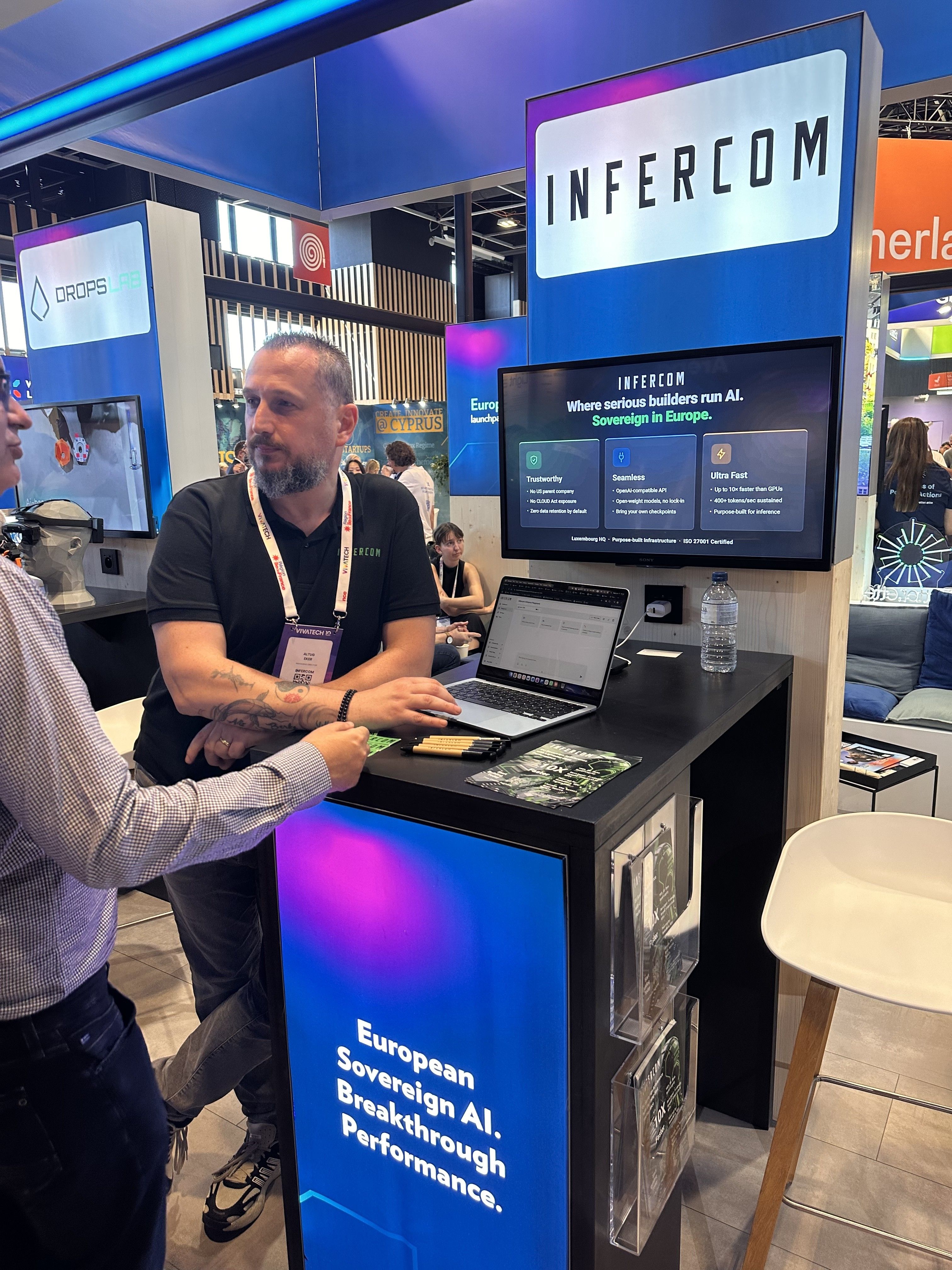 Altug Eker of Infercom listening to a visitor at the Infercom booth, VivaTech Paris
